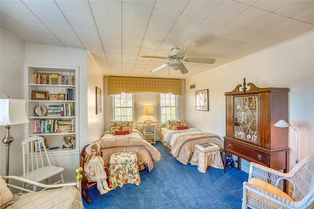 carpeted bedroom featuring ceiling fan and crown molding