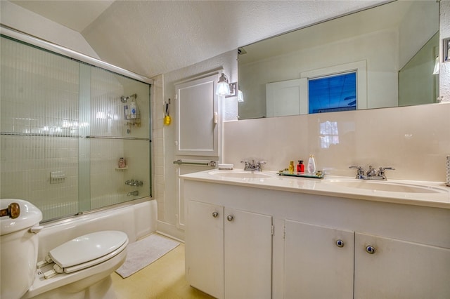 full bathroom featuring toilet, double vanity, vaulted ceiling, tasteful backsplash, and bath / shower combo with glass door