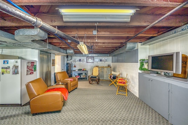 basement with light colored carpet and white fridge