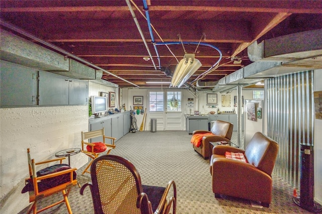 basement featuring light carpet