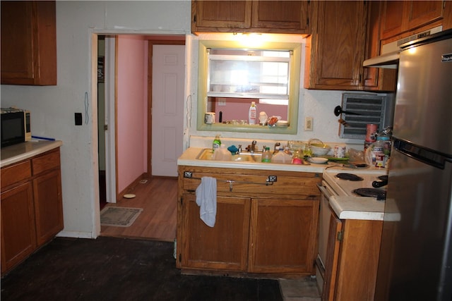 kitchen featuring stainless steel appliances, dark hardwood / wood-style floors, and sink