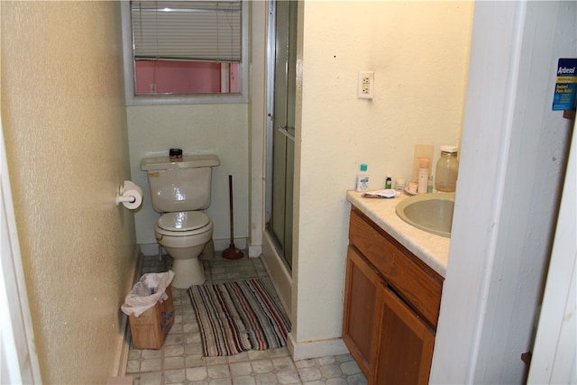 bathroom with an enclosed shower, toilet, vanity, and tile flooring