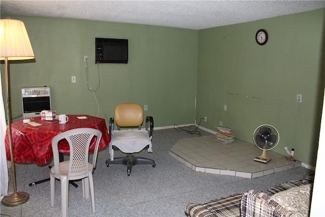 dining room with an AC wall unit, light colored carpet, and a textured ceiling