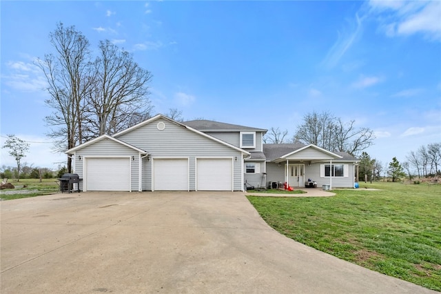 view of front of home with a front yard and a garage