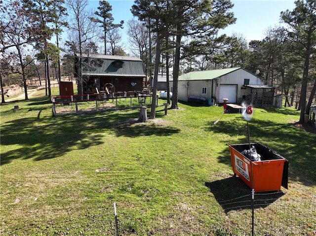 view of yard featuring a garage and an outdoor structure