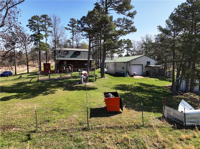 view of yard featuring a garage and an outdoor structure