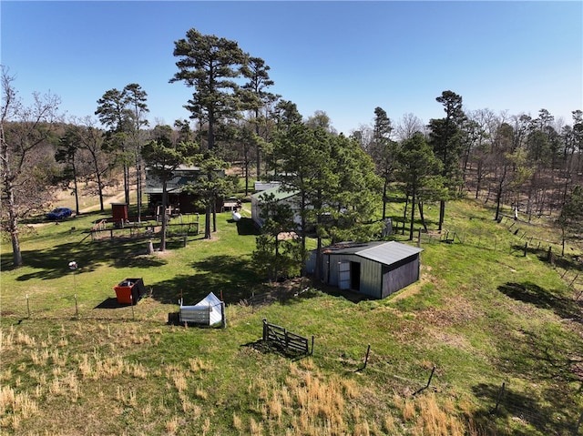 view of yard featuring a rural view and a storage shed