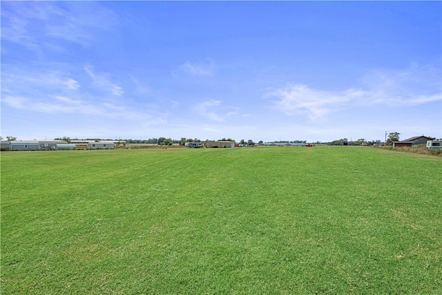 view of yard with a rural view