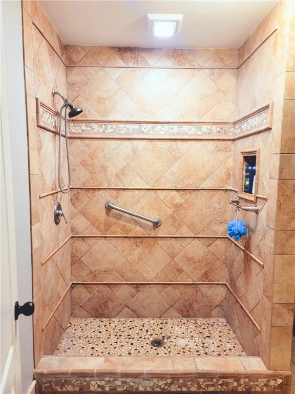 bathroom with tiled shower