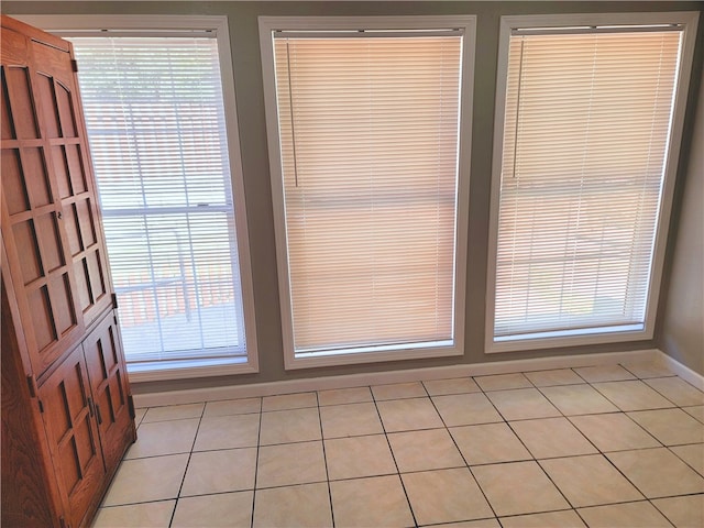 interior space with light tile floors and a healthy amount of sunlight