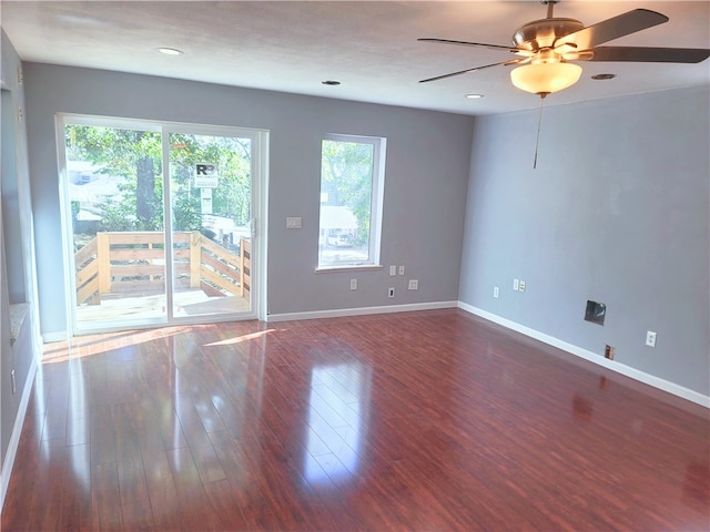 unfurnished room with dark hardwood / wood-style floors and ceiling fan