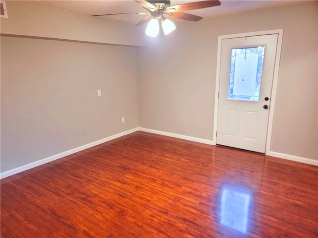 entrance foyer featuring ceiling fan and dark wood-type flooring