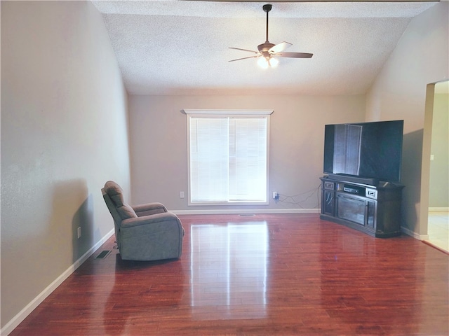 unfurnished room featuring dark hardwood / wood-style flooring, ceiling fan, a textured ceiling, and vaulted ceiling