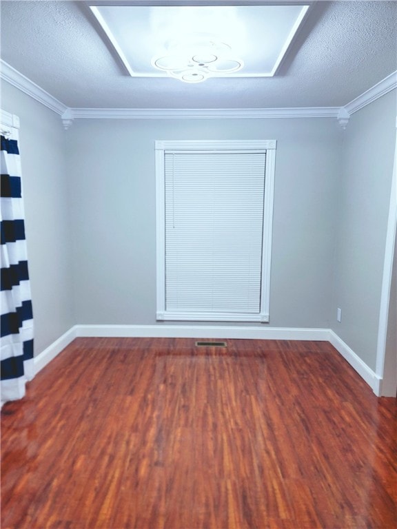 unfurnished room featuring dark hardwood / wood-style flooring, a textured ceiling, and crown molding