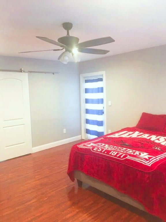 bedroom with ceiling fan and dark hardwood / wood-style floors