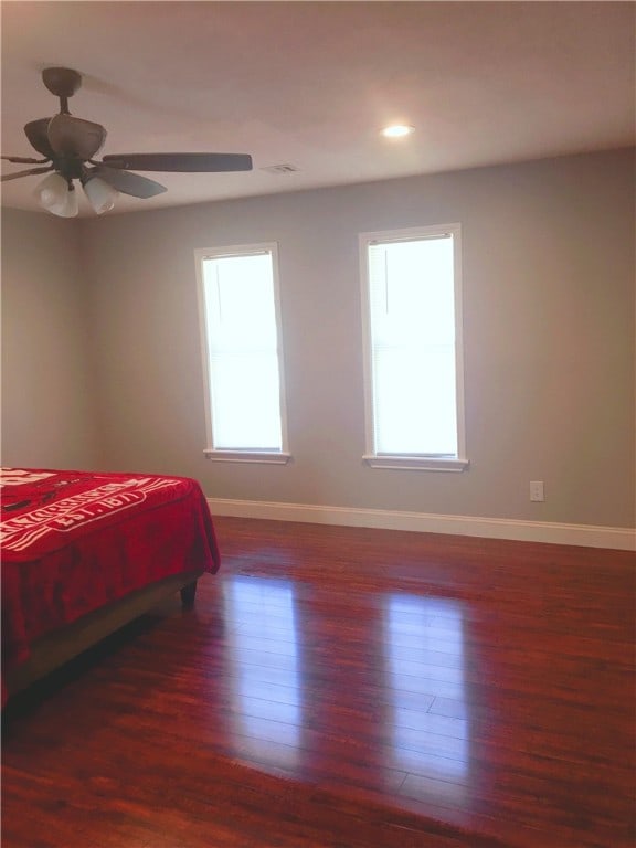 bedroom featuring ceiling fan and dark wood-type flooring