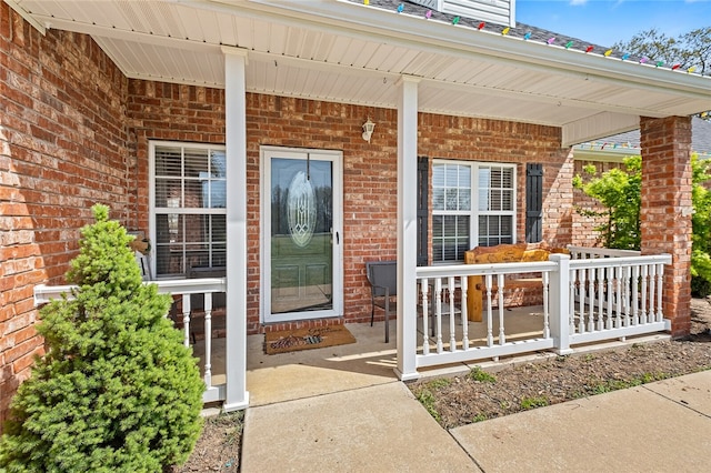 entrance to property featuring covered porch