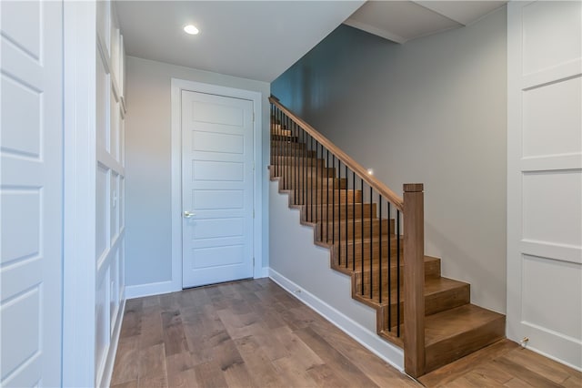 stairway featuring hardwood / wood-style floors