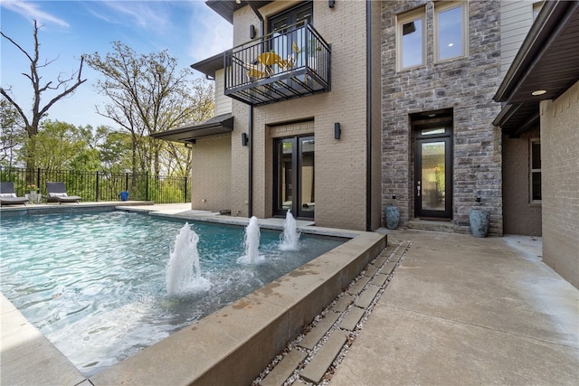 view of swimming pool with pool water feature