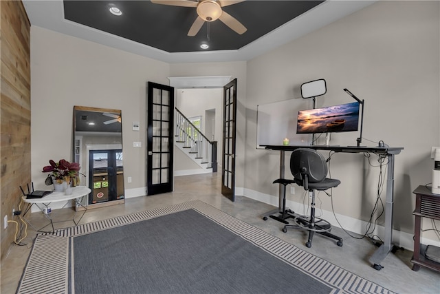 exercise room with french doors, ceiling fan, and a tray ceiling