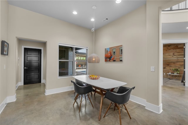 dining area with a towering ceiling