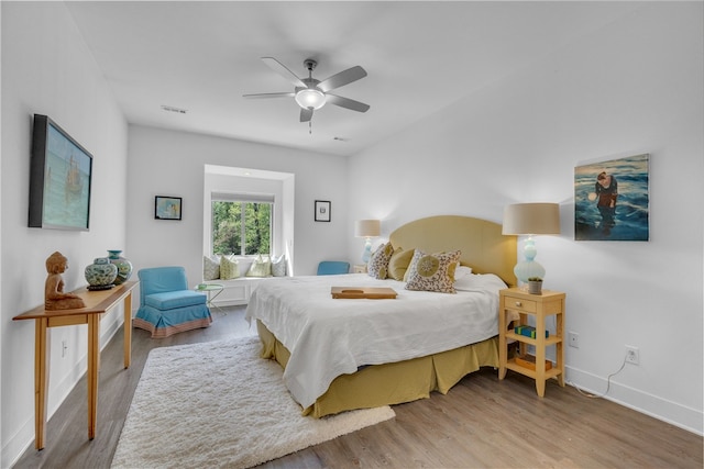 bedroom with light hardwood / wood-style flooring and ceiling fan