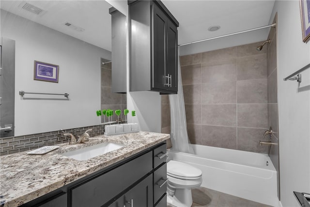 full bathroom featuring backsplash, shower / bath combo, toilet, tile flooring, and vanity