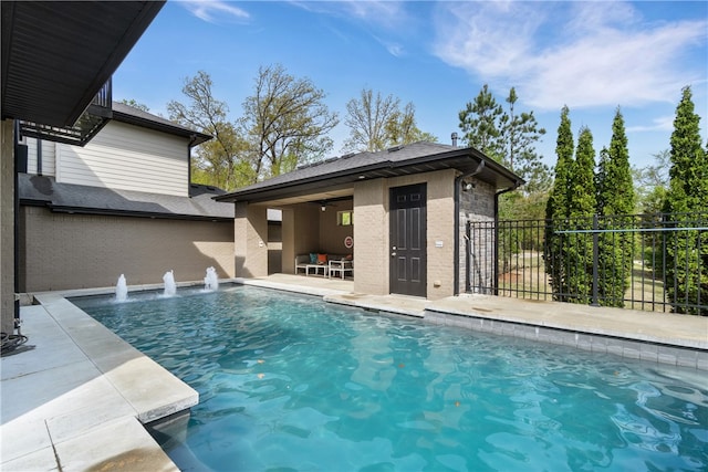 view of pool featuring pool water feature and a patio