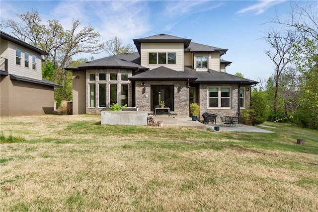 rear view of property with a lawn and a patio area