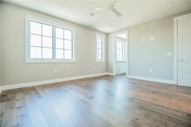 unfurnished room with ceiling fan and dark hardwood / wood-style flooring