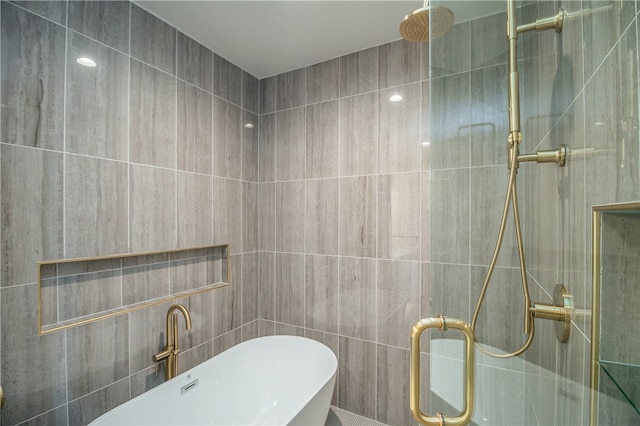 bathroom with walk in shower and tile walls