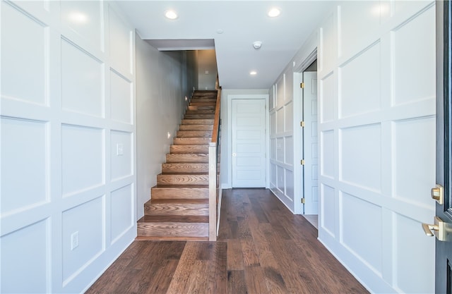 stairs featuring dark wood-type flooring