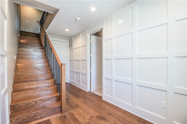 staircase with dark hardwood / wood-style floors