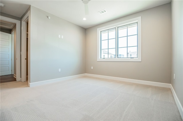 carpeted spare room featuring ceiling fan