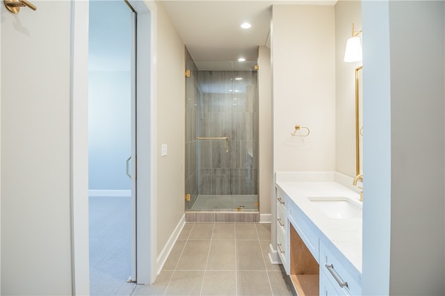 bathroom featuring tile flooring, vanity, and a shower with shower door