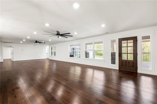 unfurnished living room featuring dark hardwood / wood-style floors and ceiling fan