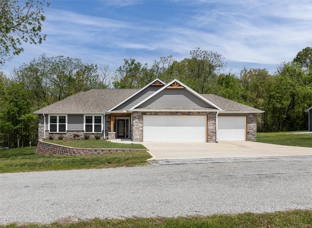 view of front of property featuring a garage and a front yard