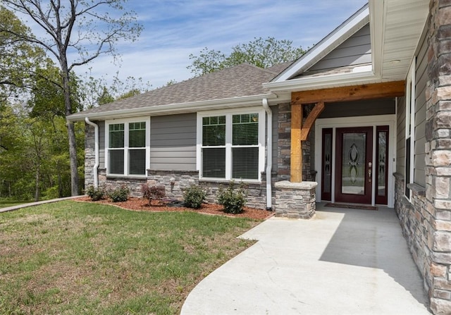 view of exterior entry with a lawn