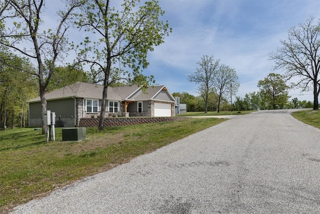 view of front of property with a garage and a front lawn