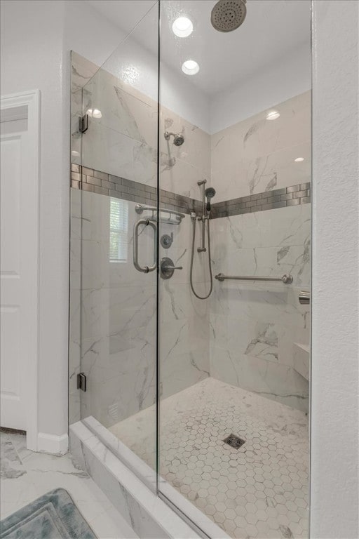 bathroom featuring a shower with shower door and tile floors