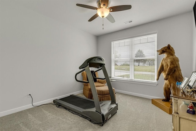 workout room with ceiling fan and carpet