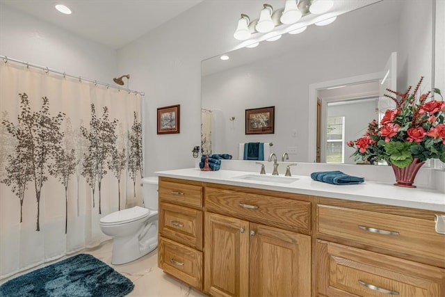 bathroom featuring tile floors, vanity, and toilet