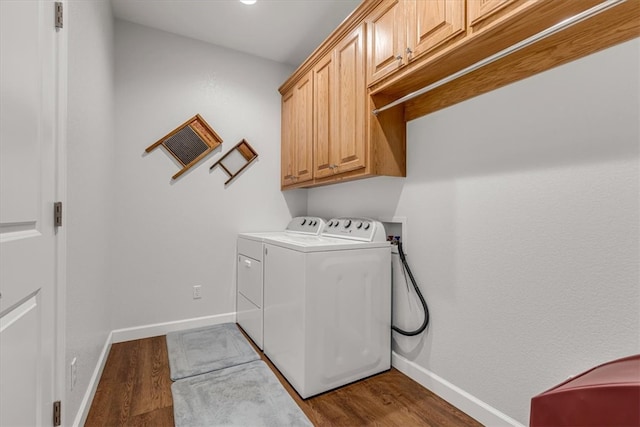 laundry room featuring cabinets, separate washer and dryer, hookup for a washing machine, and dark hardwood / wood-style floors