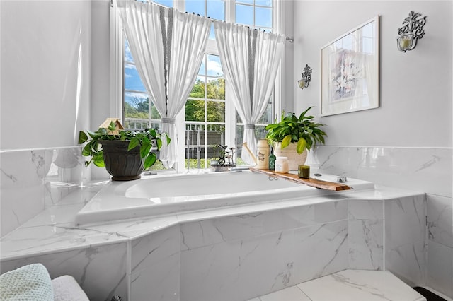 bathroom featuring a relaxing tiled bath