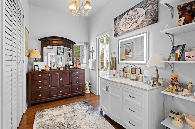 interior space featuring a notable chandelier, vanity, and hardwood / wood-style floors