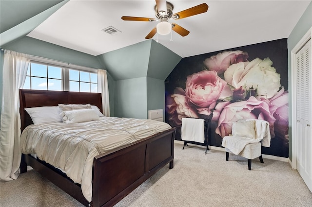 bedroom with a closet, light carpet, ceiling fan, and lofted ceiling