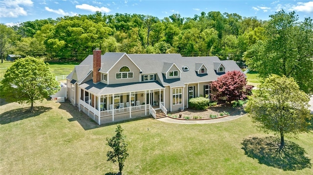 exterior space featuring a porch and a lawn