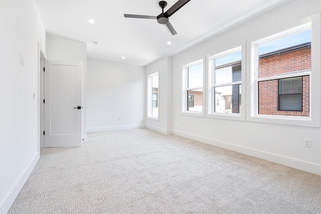 carpeted empty room featuring ceiling fan