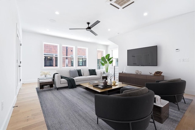 living room with ceiling fan and hardwood / wood-style floors