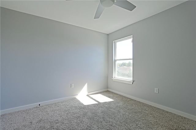 empty room with ceiling fan and carpet floors